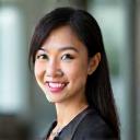 Portrait of a smiling executive, Sarah Chen, looking well-rested and confident.